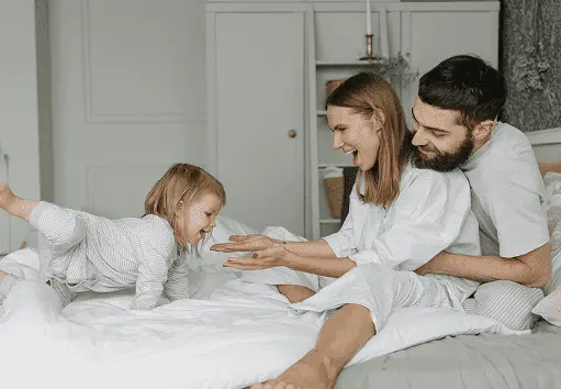 Family relaxing comfortably at home using Glacier Breeze – personal cooling system